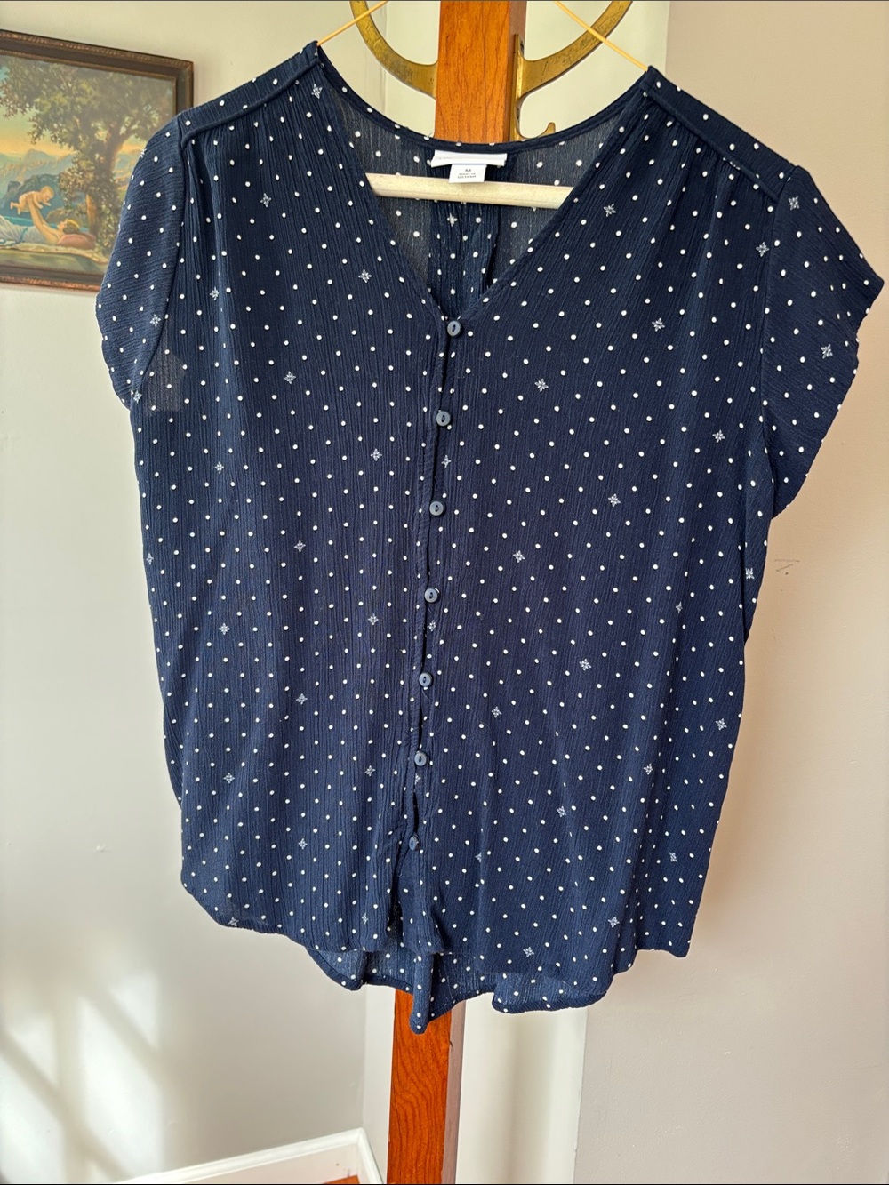 Navy blue white polka dot gauze type  blouse pleated effect on back.